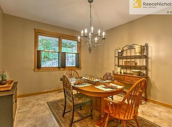 Dining room features a tile floor and is spacious enough to acco