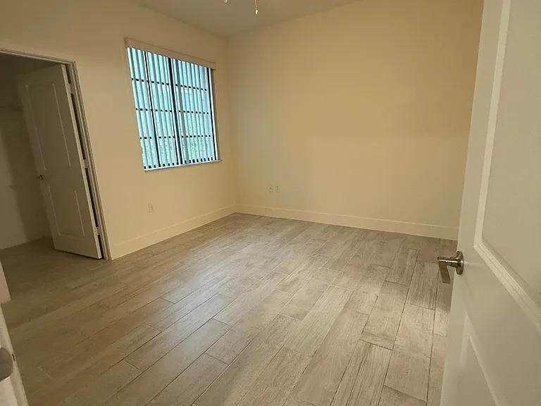 Spacious master bedroom with large window for natural light, walk-in closet, and master bath.