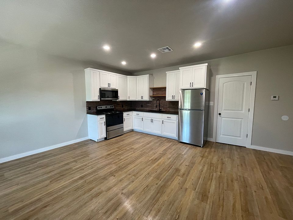Hard surface flooring throughout, open concept living and kitchen area
