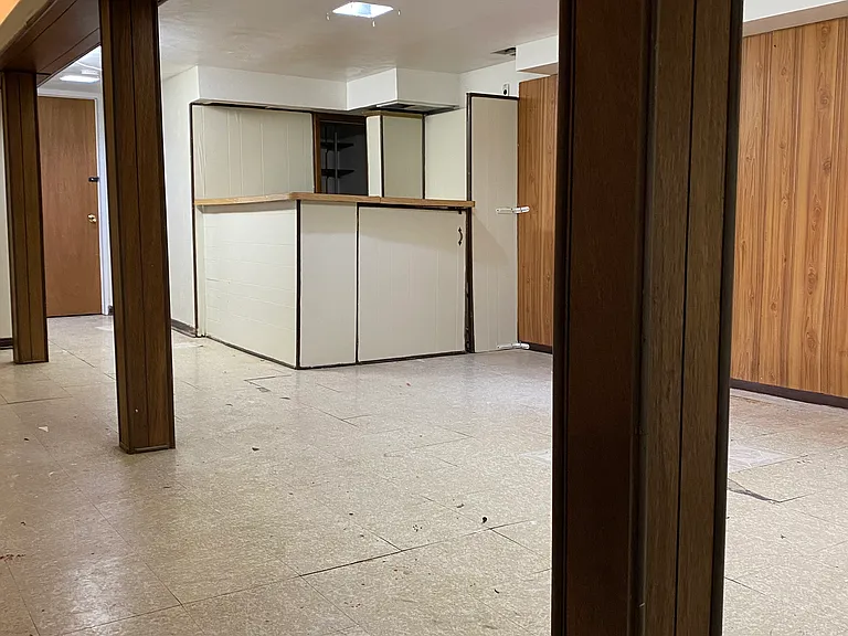 View of the finished basement from the laundry room vantage point.