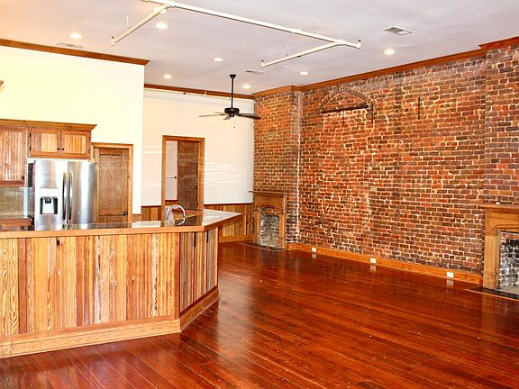Unique exposed brick wall. Hardwood features throughout.
