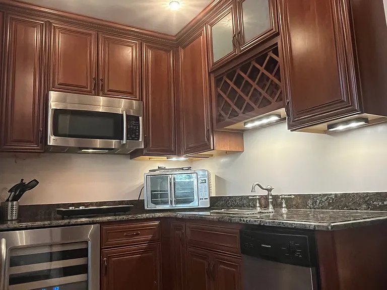 Exotic-grade granite countertop with seated bar area. Tiled kitchen floor. Lots of storage space. Fun, saddle shaped metal, adjustable stools are included in the furnishings.