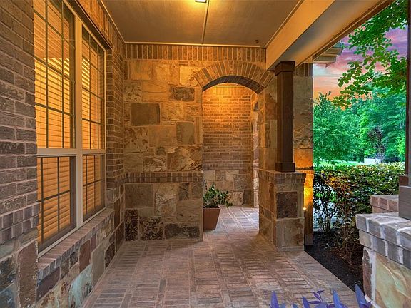 Large front porch of stone and brick...bring your rocking chairs to relax as you look at private woods &  Kinderwood Park!