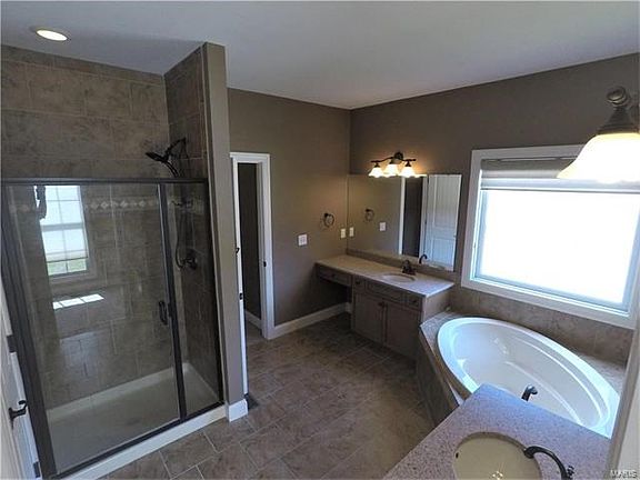 Separate Vanities ~ Large Corner Tub ~ Separate Toiletry Room.