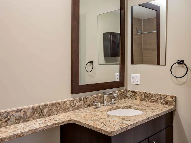 Bathrooms with upgraded finishes and glass showers in select homes