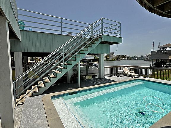 Swimming pool with bench seating and great view of the open water.