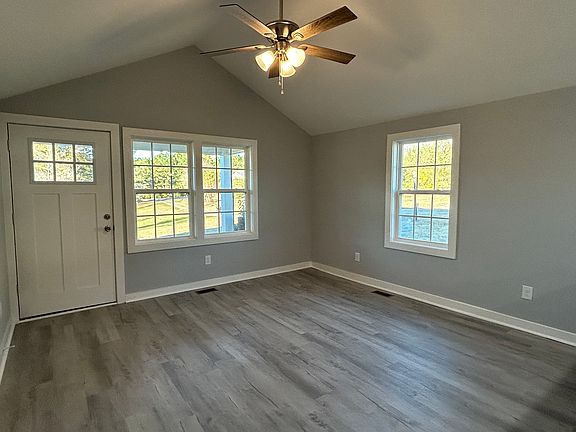Family room has vaulted ceilings and ceiling fan. LVP Flooring, fresh paint.