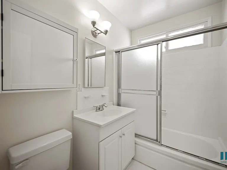 Bathroom with Shower Bath and a Glass Door