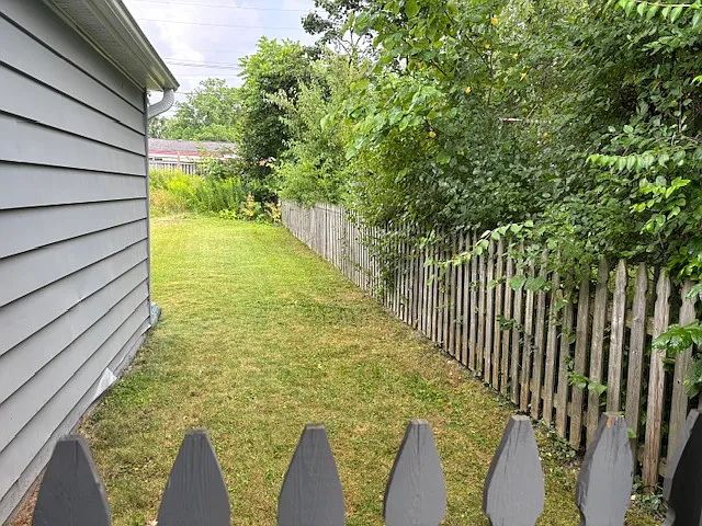 Another view of fenced backyard