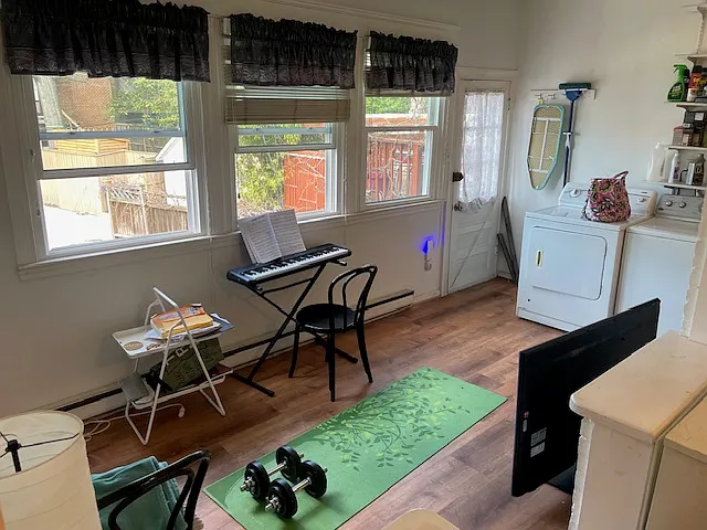 Sunroom-laundry room. Laundry shared with basement tenant.