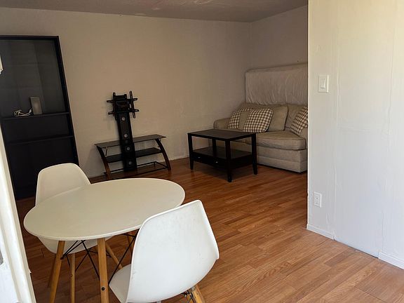 Dining table and living room to your left from the door