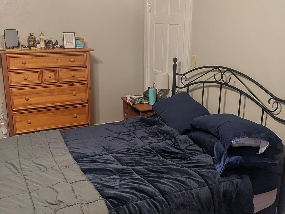 Spacious bedroom with wood floors and ceiling fan. Room for a desk to work from home.