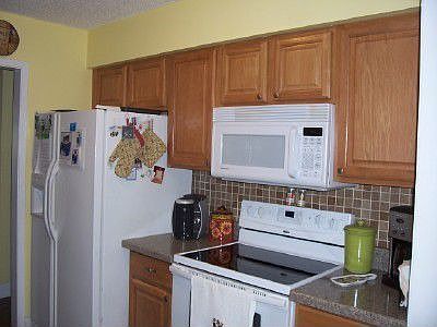 Smooth top stove, built in mircowave, and tiled backsplash.