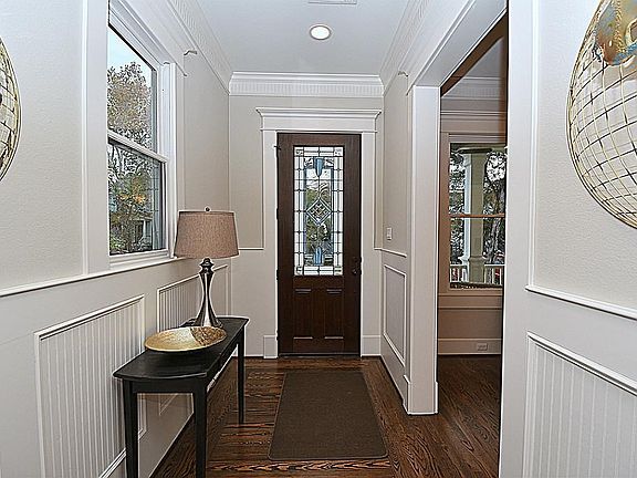Separate foyer instead of opening directly into room. Reclaimed pine floor insert at entry, solid oak elsewhere. Stained glass entry at door (and bath) by Heights artist Karen Farrell.