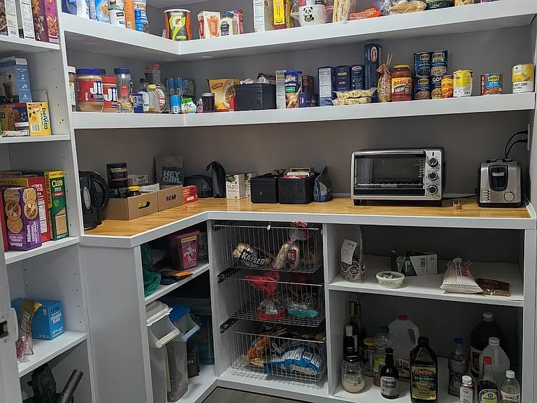 6.25' x 6.75' Large Pantry with built in shelving and drawers off of the Butler's Pantry and Kitchen.