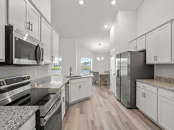 Your kitchen includes a walk-in pantry, and seating at the bar and dining cafe - Ryleigh by Highland