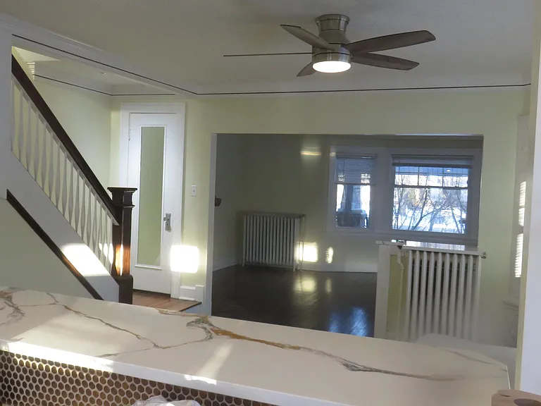 3 ceiling fans upstairs and 1 in the dining room are on wall-mounted controls--NO PULL-CHAINS (view from kitchen thru living room)