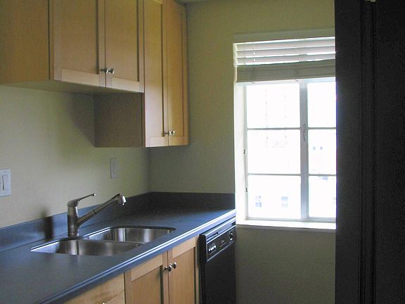 Kitchen has all appliances, newer cabinets and a city view.