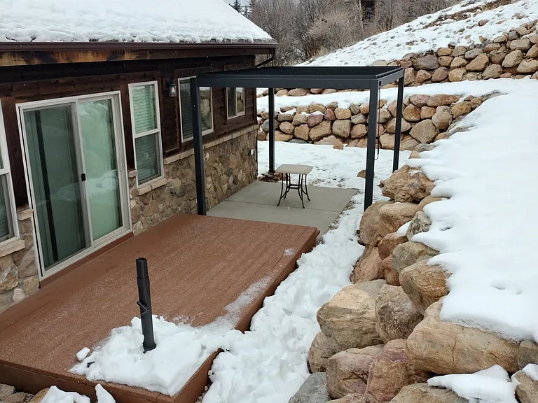 Step outside the master bedroom to a private deck with a pergola, a hot tub pad, and a new hot tub installed before renting. This intimate space is perfect for enjoying the fresh mountain air and serene evening views.