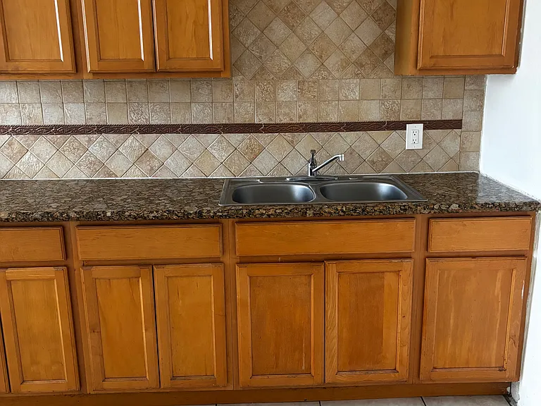 Large kitchen with beautiful granite countertops and tile backsplash