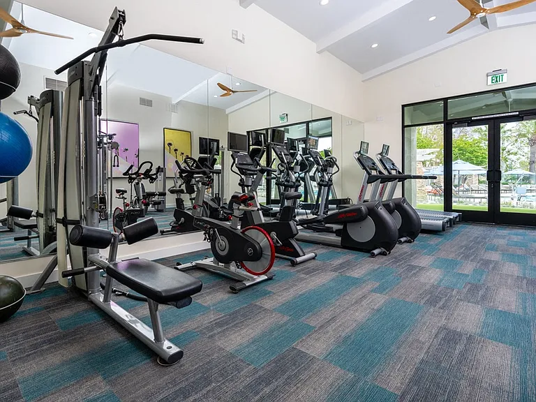 Fitness Center Featuring Cardio Machines, Weight Equipment, and Pool View