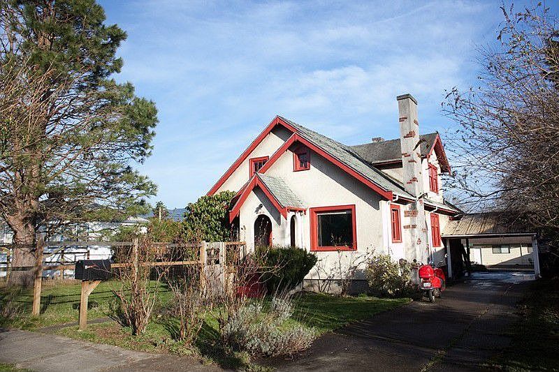 Front view shows new roof, pretty garden & chimney detail.