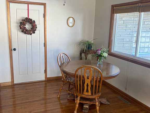 Dining Room with sliding glass windows and blinds. Door leads to garage. Comes unfurnished.
