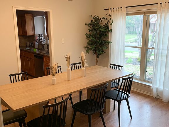 Large dining room with crown molding and large windows with natural light