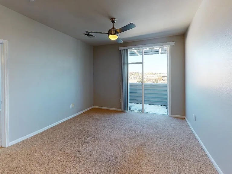 Spacious apartment bedroom with plush carpet flooring