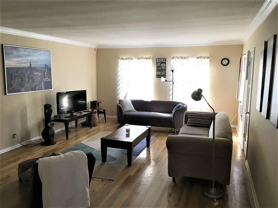 This is the main living room, which is immediately to your right upon entering the apartment. Two sofas, 1 futon, coffee table, two reading lamps, a window AC unit in the windown near the clock, and TV equipped with Firestick.