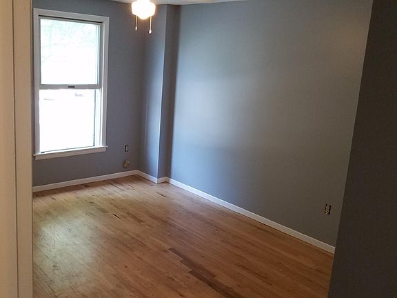 3rd Bedroom on Level 2 with plenty of sunlight through window & has ceiling fan with light, wooden floor & large closet