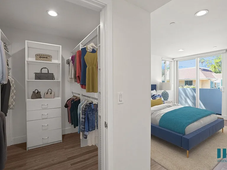 Bedroom with Walk-In Closet with Built-In Organizers, Vinyl Flooring, Recessed Lighting, and Patio