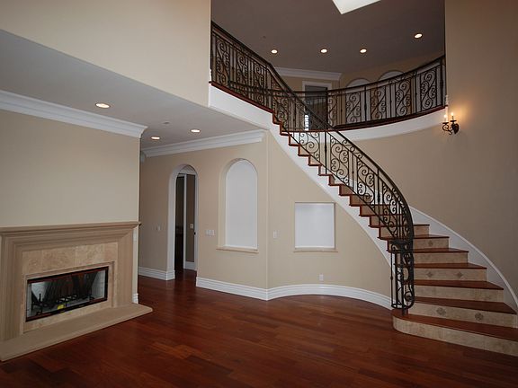 Living Room W/ Fireplace, Sweeping Staircase