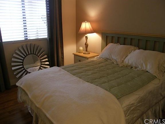 Each bedroom is sunny, with new flooring and tasteful neutral paint and décor.  This bedroom has a walk-in closet.