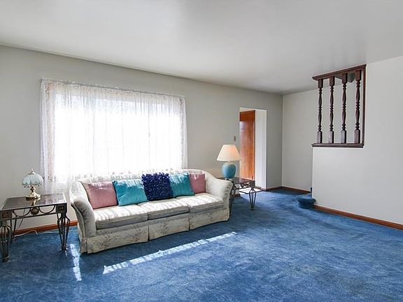 Living room with hardwood underneath carpet.