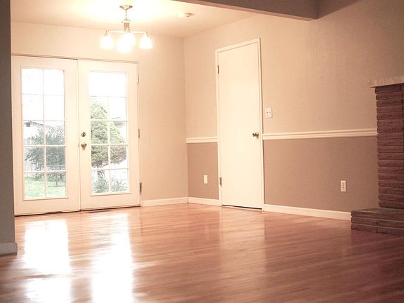 Two-tone paint in living room and french doors to backyard
