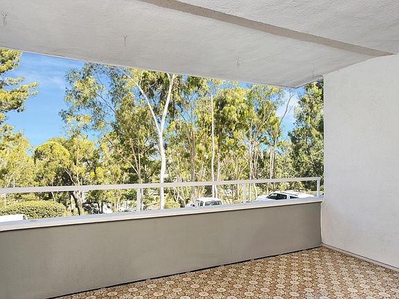 Large covered deck with views of trees and parks.