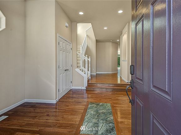 As you enter the home, rich hardwood floors invite you in. 