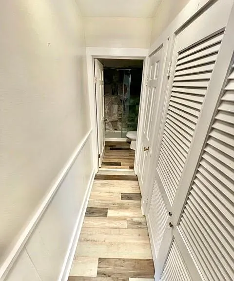 Hallway to bathroom, linen closet, and utility closet.