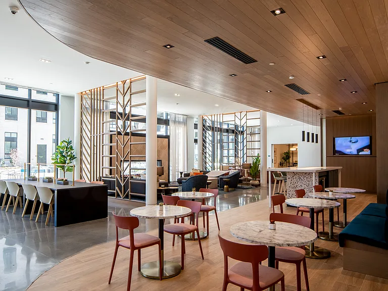 Our amenity core at Wellsmith includes a fireplace lounge, an entertainment kitchen, gaming tables and spaces to gather or work from home