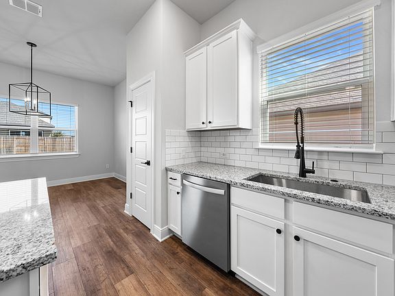 The kitchen has sprawling granite countertops.