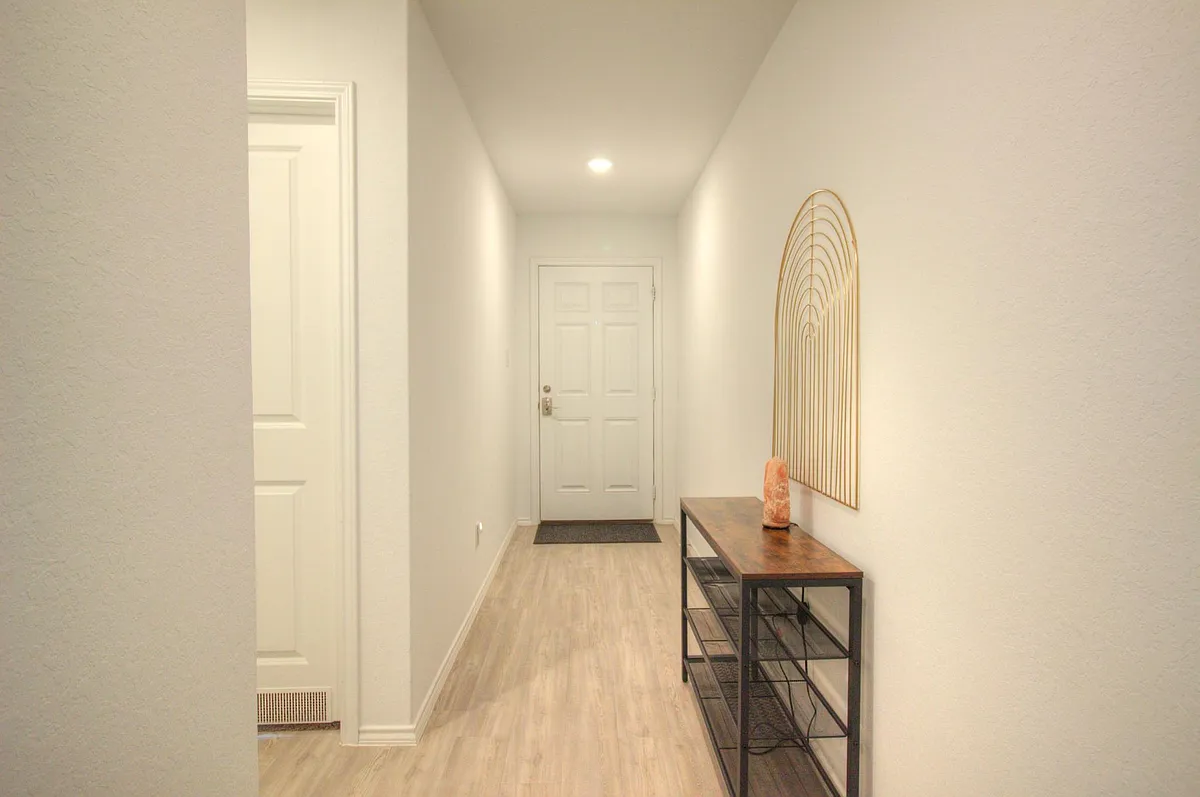 Hallway, access to bedroom 1 and bathroom 1 on left. - 5423 Elm Valley Dr