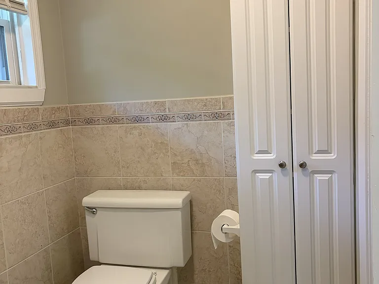 Spacious primary bathroom with a double-sink vanity, walk-in shower, and generous cabinet storage.