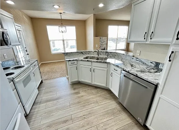 Kitchen with granite countertops and plenty of counter space and cabinet space.