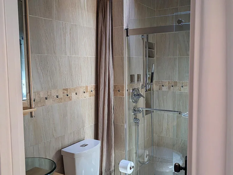 Completely remodeled bathroom with venting skylight in the shower
