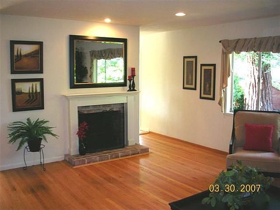 fireplace in living room with upgraded directional recessed lighting