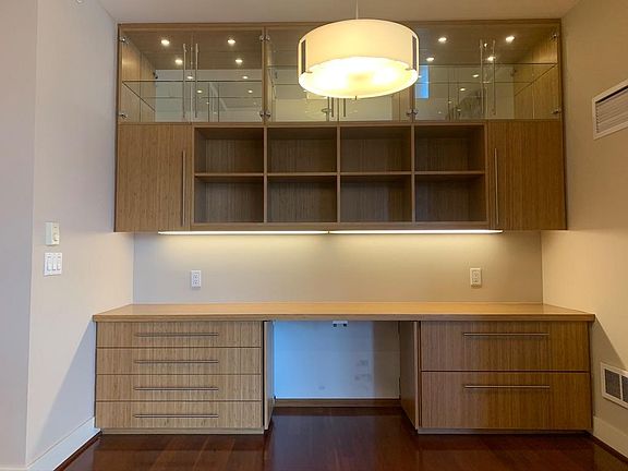 Custom-built desk/buffet combo with task lighting, pull-out printer tray and wine storage