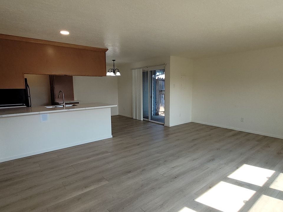 kitchen, dining, living room has nice southern facing windows and a sliding glass door out to the covered patio