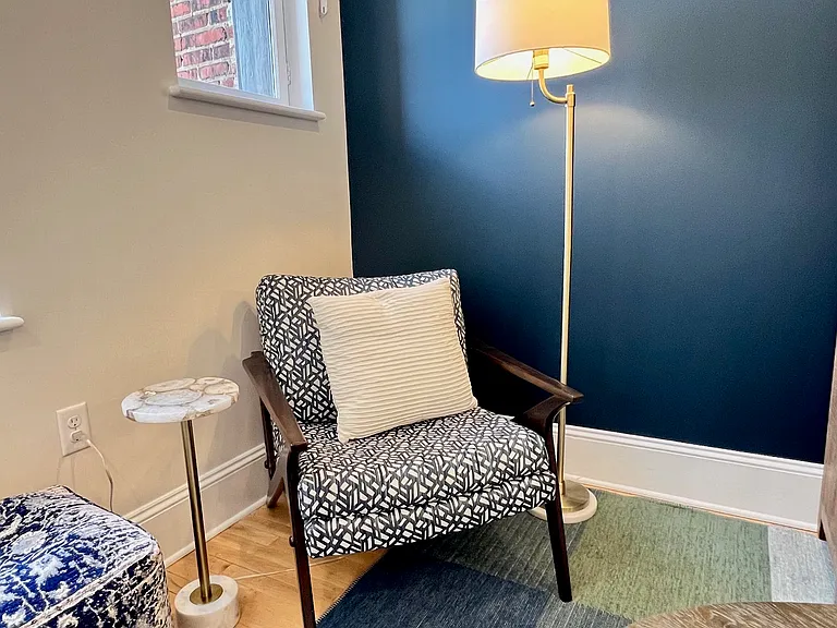 Great reading nook with drinks table. Pouf on the left for extra seating.