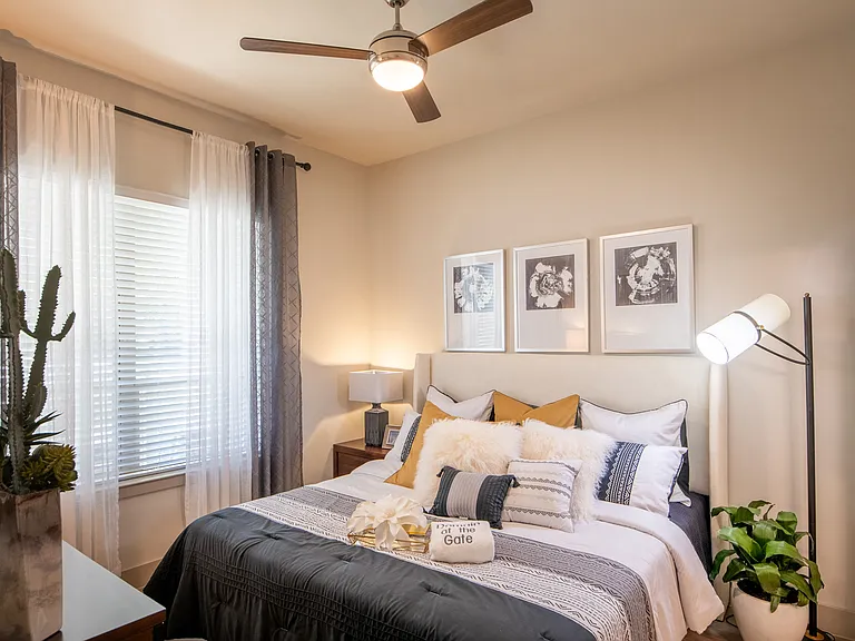 Cozy Bedroom Featuring Plush Bedding and Ceiling Fan
